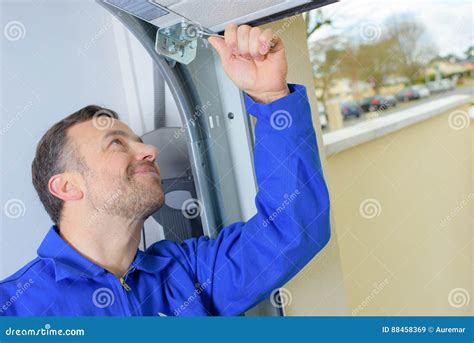 Man installing garage door stock image. Image of remodel - 88458369