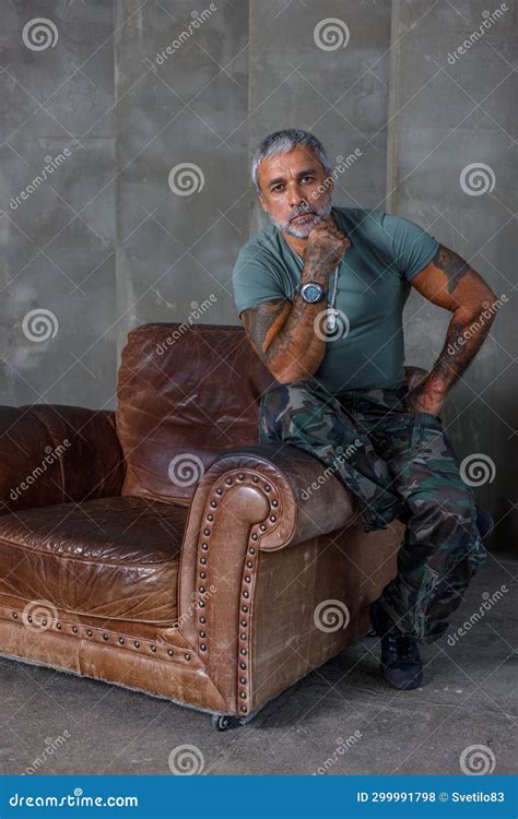 A Soldier in Camouflage, a Soldier Stands Against the Wall.a Mature ...