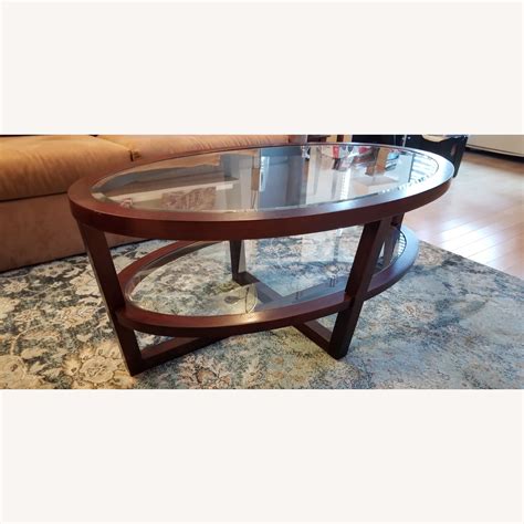 Raymour & Flanigan Oval Two Tier Glass & Wood Coffee Table - AptDeco