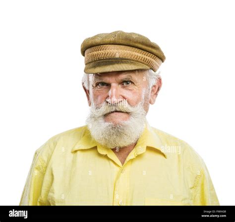 Portrait of old bearded man in traditional cap, posing in studio on ...