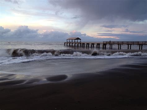 Black Sand Beach in Waimea, Kauai with Waimea Pier