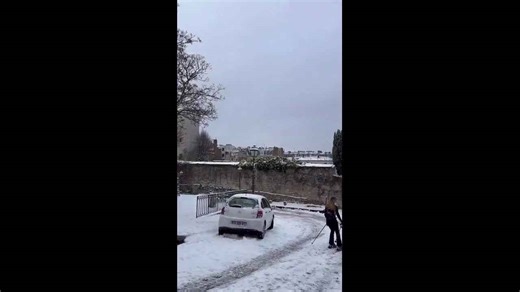 Woman skis through Montmartre streets amid rare snowfall in Paris, France
