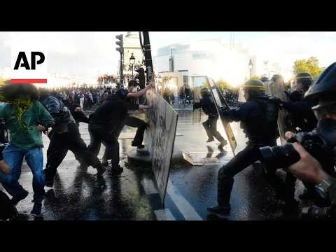 Police detain protesters in Paris as they moved in with tear gas