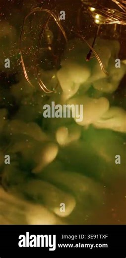 Vertical video. Fume explosion. Art fog. Broken glass bokeh light bulb glowing garland abstract sparkling water. Green gray smoke blend color ink background Stock Video Footage - Alamy