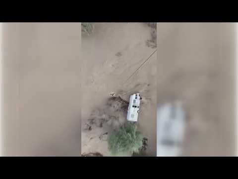 WATCH: Helicopter crew rescues people from RV overturned in floodwaters