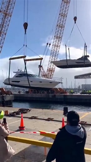 Yachts Hanging on Cables in the Harbor… One Suddenly Drops 🛥️⚓️ Two yachts are suspended on lifting cables in the port—then one strap slips and the yacht crashes down hard. Workers freeze, everyone starts yelling, and the only question is: who’s responsible for the damage now?! #yacht #fail #wtf #fail #reels | The.worldai
