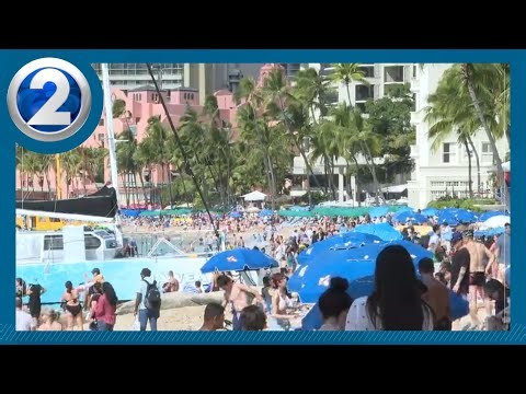 Visitors pack Waikiki Beach on Christmas Day, a sign tourism closing year out strong