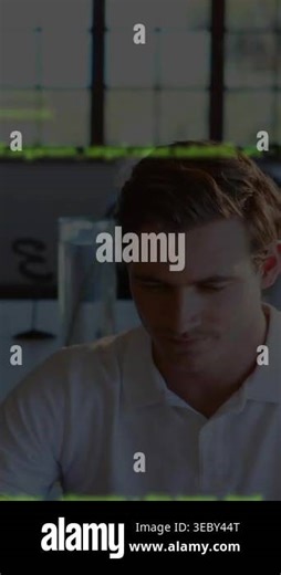 Vertical video: Developer reviewing code overlay appearing over face, sipping mug, using tablet. Coding, office, grid, device, focus, concentration, vertical video Stock Video Footage - Alamy