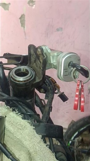 To remove this ignition switch, you must open the bodywork and detach the handlebar assembly