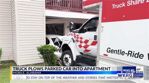 U Haul hits car, pushing it into apartment