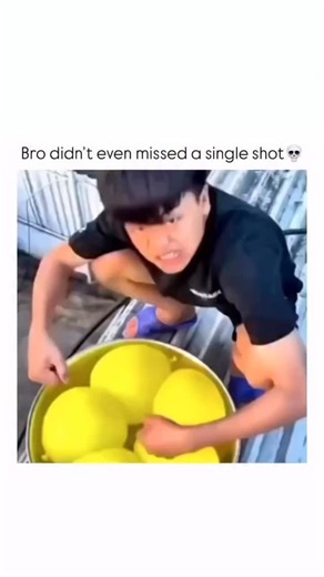 B O R N F I R E on Instagram: "The video captures a playful water fight or game, likely taking place on a patio or rooftop, centered around a man with a large basin of water balloons. The video begins with a close-up of a young man crouching over a large yellow basin filled with bright yellow water balloons. He is wearing a dark t-shirt and shorts, with a look of intense concentration or mischievousness on his face.The camera then quickly switches to a high-angle shot, showing a large, shallow p