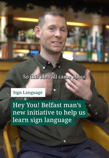A Belfast man who has been profoundly deaf since birth has said that he hopes his new initiative to help the public learn sign language while waiting in queues will make the city more accessible for the deaf community. Anthony Sinclair, who runs sign language business Sign Source, recently launched an initiative to introduce learning resources into venues across Belfast. These signs, pamphlets, stands and coffee cup holders aim to teach members of the public how to sign their name using the Brit