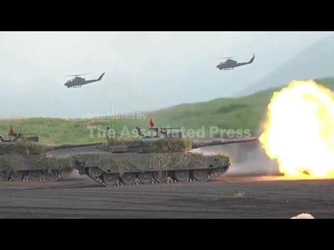 Japan's cabinet approves record defense budget that aims to deter China; AP explains