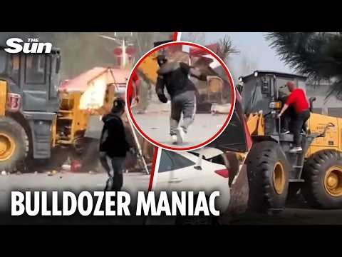 Moment bulldozer smashes into busy market before hero drags driver away from the wheel