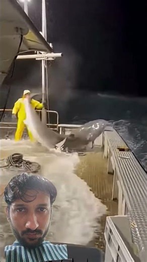 A massive wave crashes over the side of a boat at night