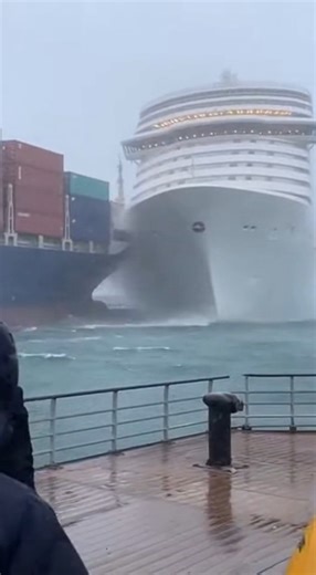 Cruise Ship Collides With Cargo Vessel and Capsizes in Shocking Harbor Accident Undisclosed Port City — A crowded waterfront fell silent as a massive cruise ship slammed into a container vessel and began to capsize, the catastrophic collision unfolding in full view of stunned onlookers lining the shore. Video from the scene shows the towering bow of the cruise ship drifting dangerously close to a cargo ship stacked high with containers. Within seconds, the two vessels collide. The impact sends a