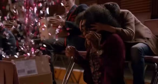 “My hand was moving before I could think better of it, reaching for the smooth corner of the dark lid so I could—BOOM! I jumped as everything erupted. The second my finger nudged the lid open, it triggered a loud explosion of gold confetti and red glitter.