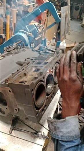 REPAIRING EXCAVATOR'S ENGINE BLOCK DURING CYLINDER HEAD MIG WELDING IN WORKSHOP