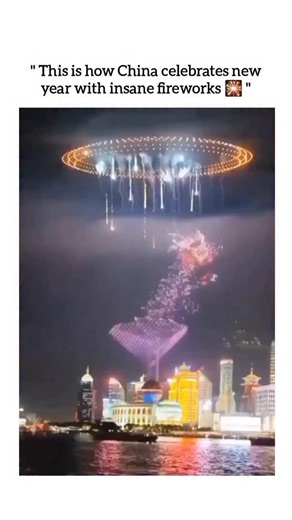 UNIVERSAL REEL HUB on Instagram: "This viral 10 seconds reel captures a breathtaking display of advanced drone technology and pyrotechnics over the Shanghai skyline, featuring a massive, shimmering golden dragon that appears to soar through the air beneath a glowing circular halo. The synchronized drones perfectly mimic the fluid movements of the mythical creature, trailing sparkling lights and smoke against the backdrop of the Oriental Pearl Tower to create a futuristic fusion of traditional Ch