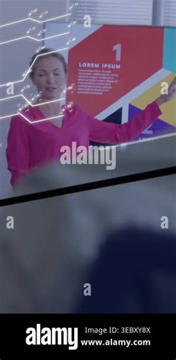 Presenting host pink-top pants starting talk explaining pointing to screen in meeting-room with AR. Woman, speaker, presentation, infographic, overlays, display, vertical video Stock Video Footage - Alamy