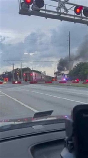 Fire is seen near a train in Oakland Park