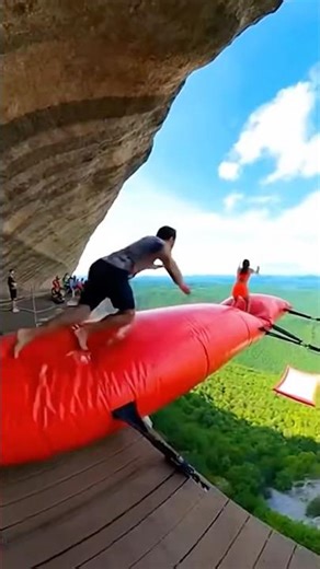 Ultimate Cliff airbag is wild! 😱🔥 Guy jumps on net girl flies! #ScaryRide #TravelWonderGuy