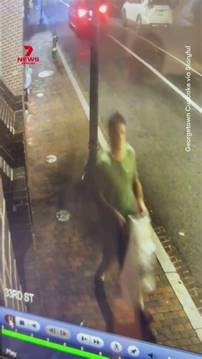 Bizarre moment man throws keg through bakery window