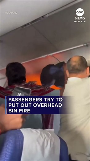 Passengers try to put out overhead bin fire