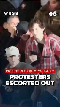 Protesters are escorted out during President Trump's Rally