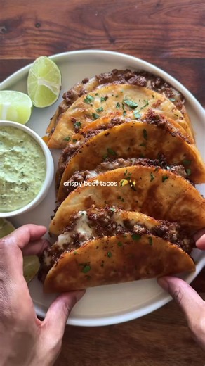 crispy beef tacos- cheesy ground beef tacos with a crispy tortilla shell served with homemade cilantro lime sauce #beef #tacos #Recipes #foodtok