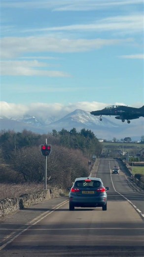 Driver Spots Low-Flying Plane Near Mountains