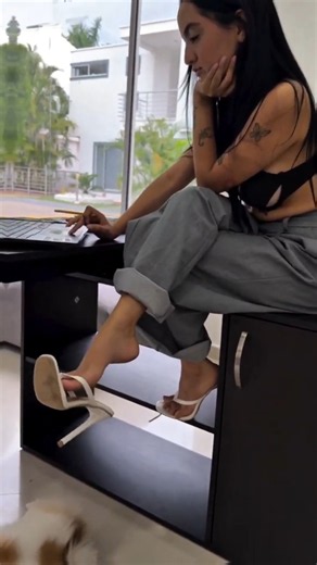 Girl Dangling heels in office