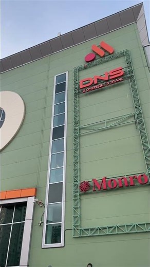 Young Man Kicks Basketball Onto Building Sign with Precision