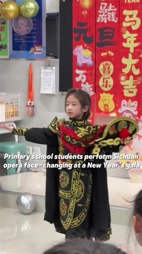 Primary school students perform Sichuan opera face-changing at a New Year’s gala.