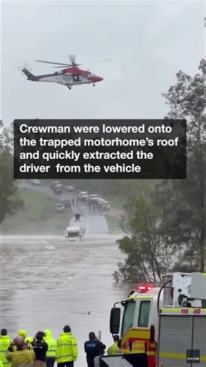 Rescue crews winch driver to safety after misjudging flooded crossing
