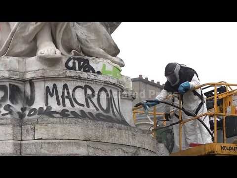 Shop owners and volunteers clean up after riots in Paris