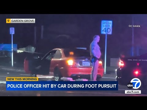 Officer in critical condition after being hit by car while running after suspect