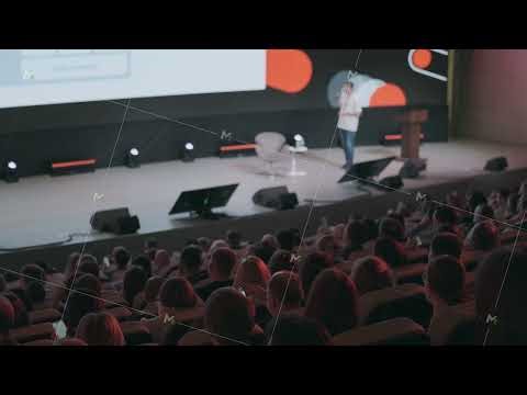 TechWeek conference presentation with speaker on stage and attentive audience in modern auditorium