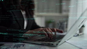 Hands typing on laptop keyboard with overlay of programming code, concept of technology, software development, and