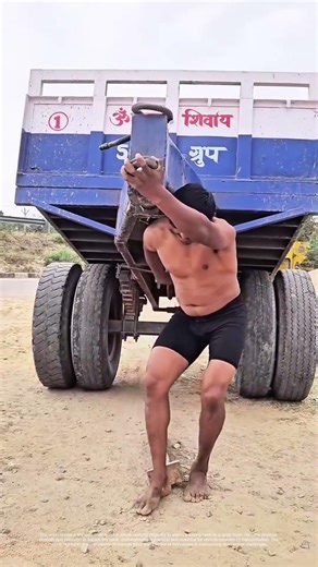 Harnessing Strength: How a Man Manually Connects a Truck's Towing Hook