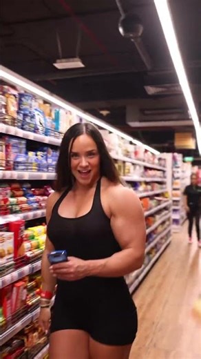 Big Biceps Fbb Woman bodybuilder FLEX in a Store…