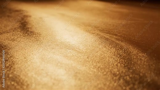 Elegant gold glitter texture background with soft light and shimmering metallic particles.
