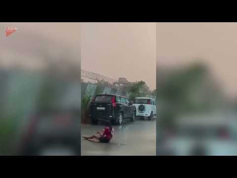 Woman Slips and Falls While Filming Rain - 1840691
