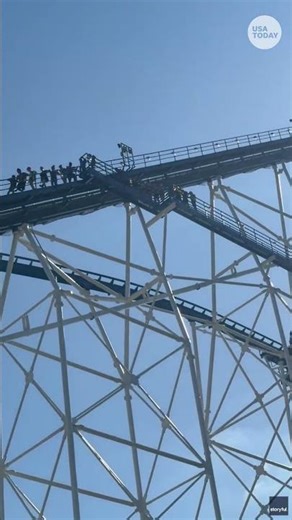 Riders walk down huge coaster at Six Flags Over Texas