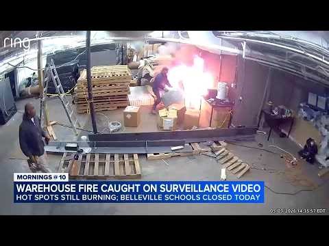 Start of enormous warehouse fire seen on surveillance video