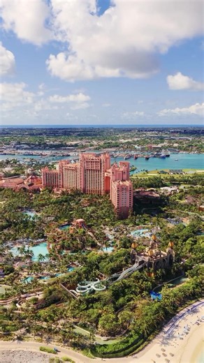 From up here, you get the full picture of what makes Atlantis Paradise Island so special. 💙 The contrast between the deep blue ocean, the clear inland lagoons, and the sheer footprint of the resort is something like no other. Explore Atlantis in The Bahamas through the link in our bio. 🎥 IG: alittlebitofe_