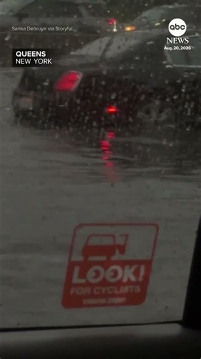 Vehicles crawl through several inches of floodwater on NYC freeway
