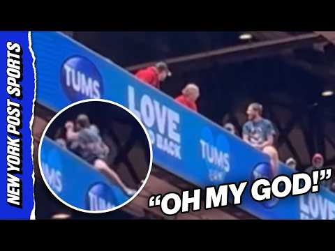 Cardinals fan DANGEROUSLY hangs off upper deck ledge then FIGHTS fans trying to save him!