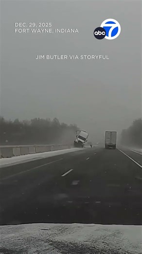 Semi-truck launches over highway barrier