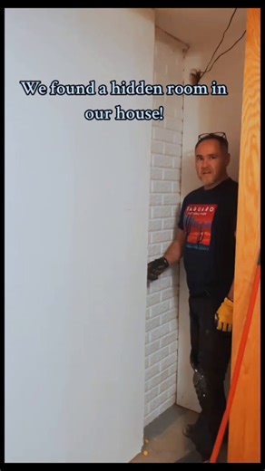 This couple found a hidden room in their house!The husband pulls open what looks like a normal wall panel and reveals a whole secret room they had no idea was there — even after living in the house for four years. It has a heavy metal door, a drain in the concrete floor, and some rust stains. They’re guessing it was probably an old panic room.The pure shock and excitement as they explore it is so real.What’s odd is that there doesn’t seem to be a lock on the inside of the door or even a handle t